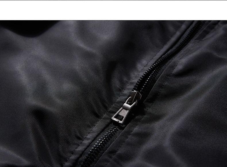 Black jacket zipper close-up with metal pull and stitched placket