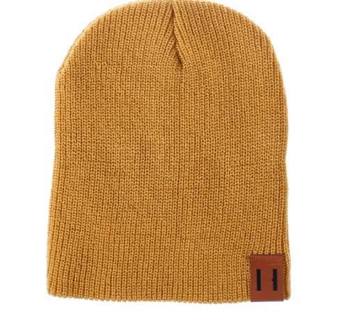 Camel knit beanie hat with foldover cuff and brown logo patch