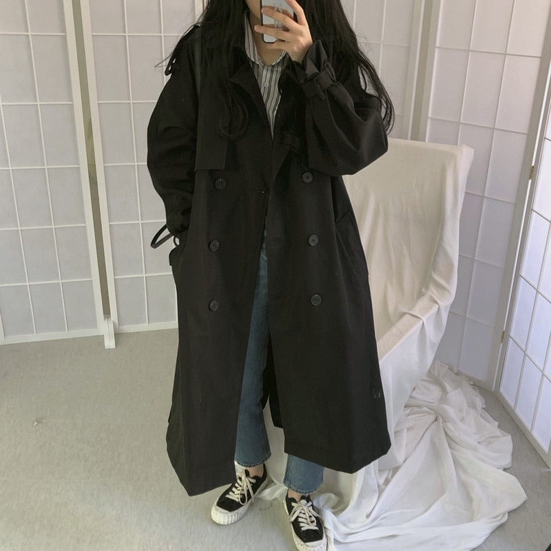 Black long trench-style overcoat with double rows of buttons and wide lapels