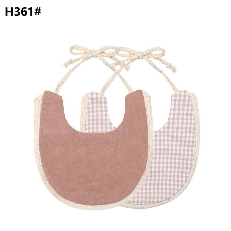 Double-sided cotton baby bib with tassel ties; dusty rose and gingham plaid.