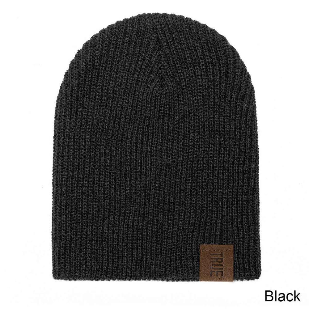 Black kids knit beanie hat with ribbed texture and leather brand patch