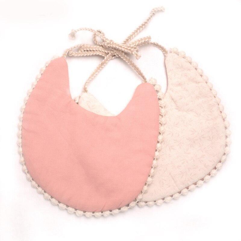 Infant bib set with dusty pink solid front and blush textured back, pom-pom trim