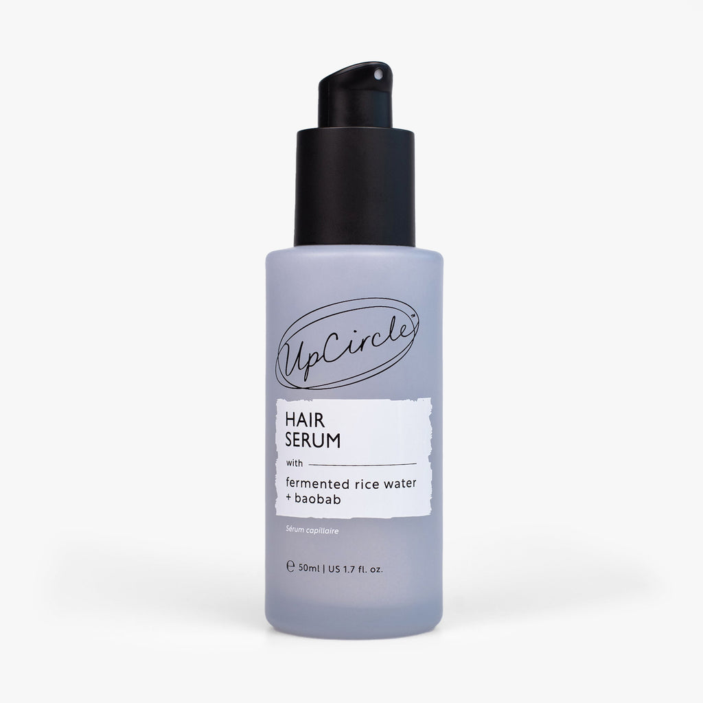 Hair serum bottle with black pump and light lavender label, 50 ml size