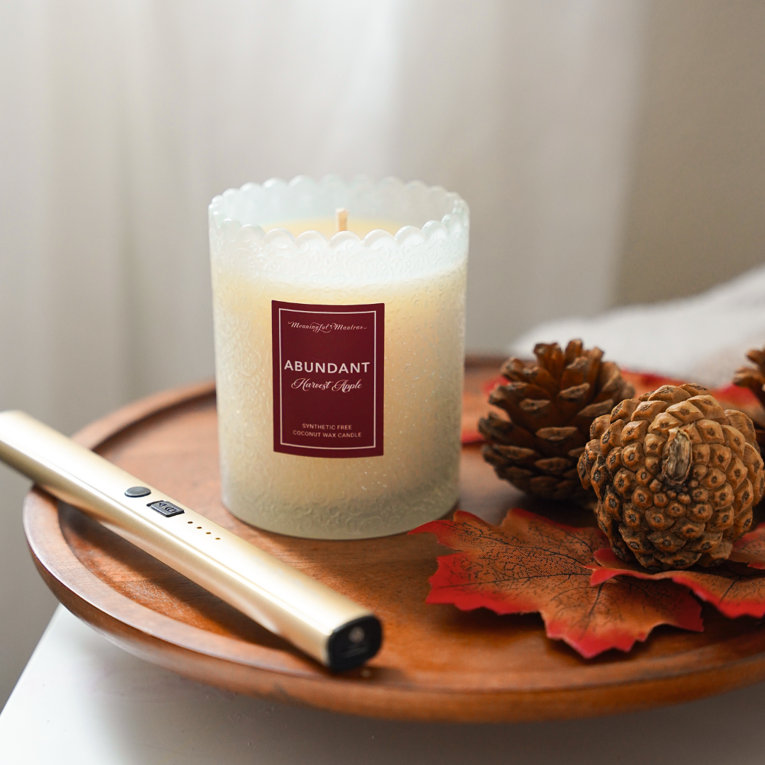 Frosted white pillar-style coconut wax candle with scalloped rim and red label