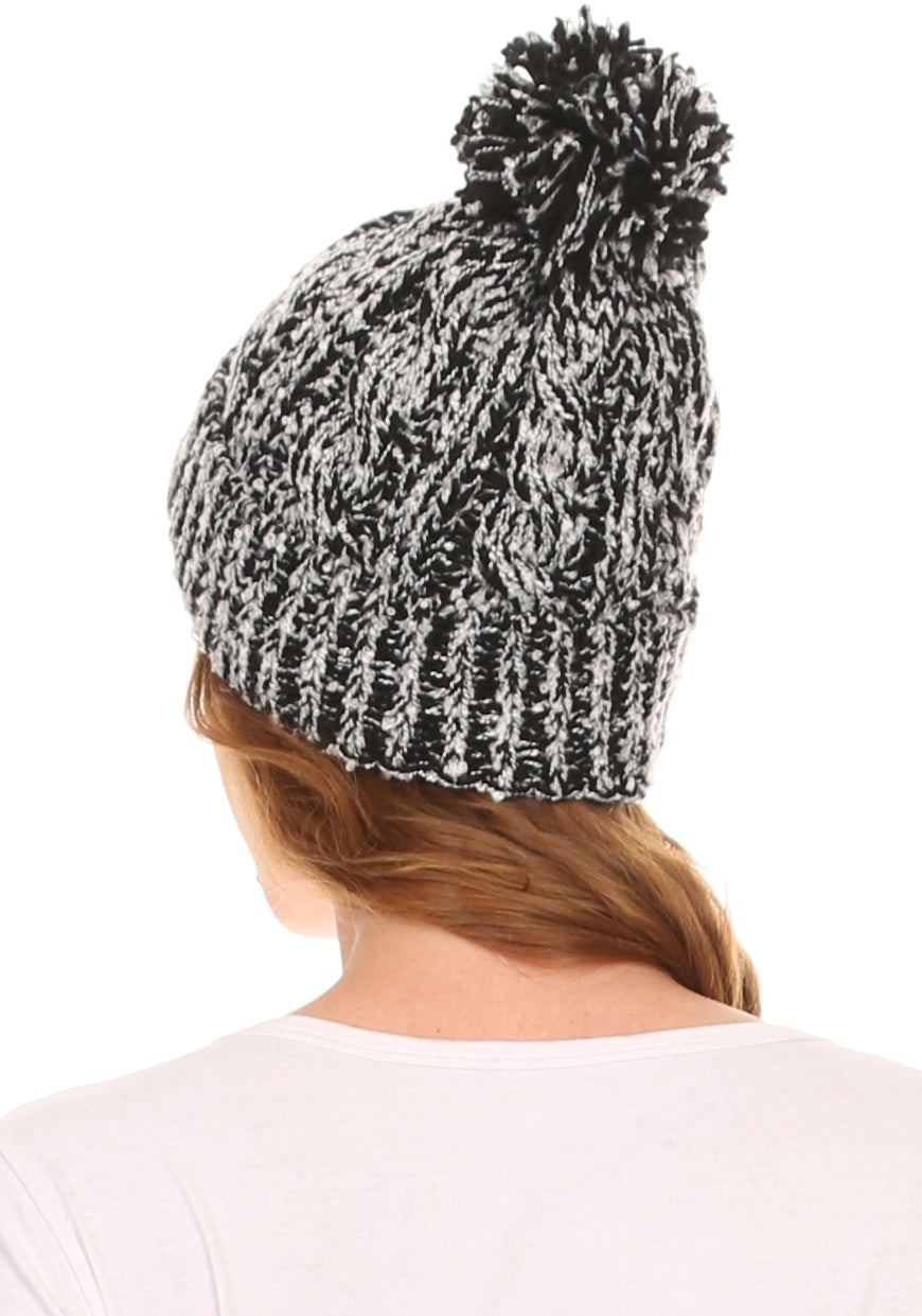 Black-and-white speckled knit beanie with pom pom, shown from the back.