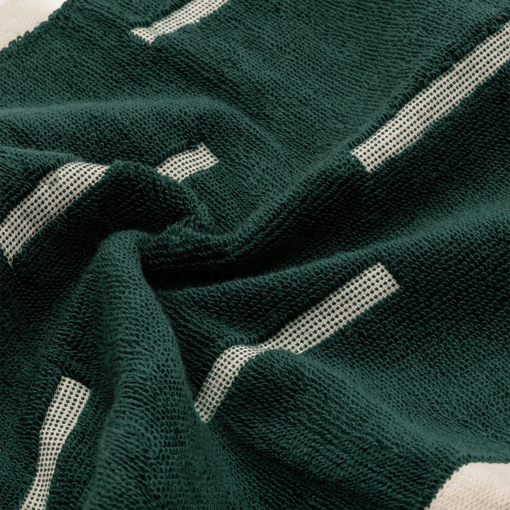 Verdant green cotton towel with ecru geometric stripe and textured terry weave