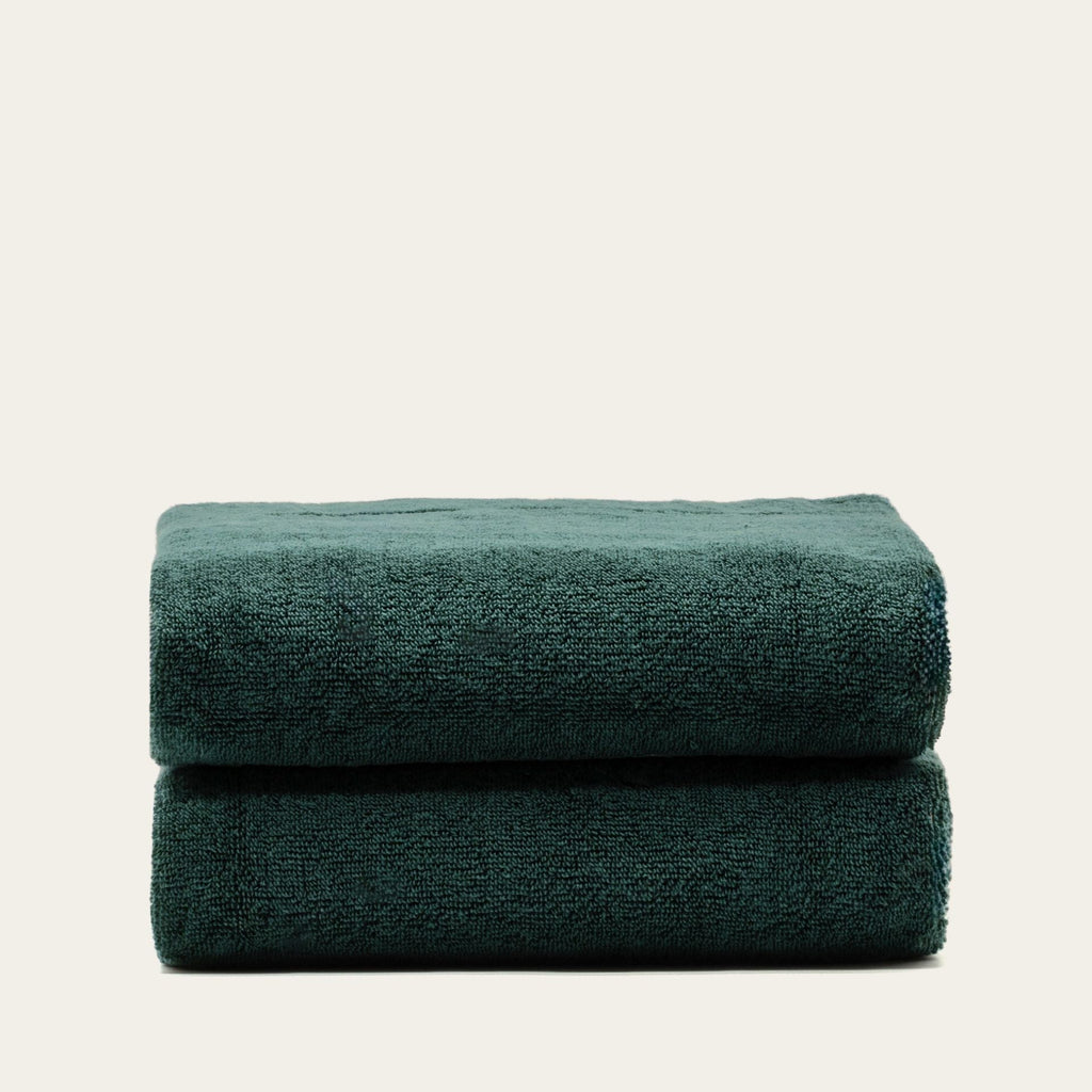 Australian cotton towel in verdant green, folded into a double roll