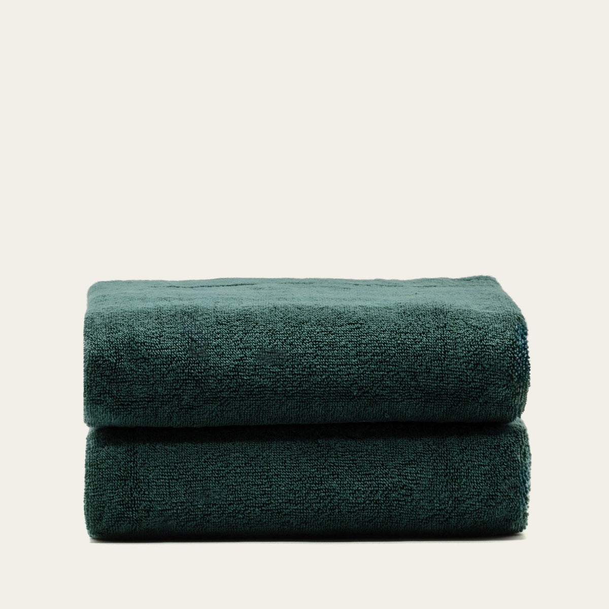 Australian cotton towel in verdant green, folded into a double roll