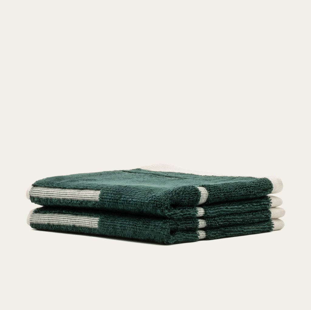 Australian cotton towel set in verdant green, folded stack with white stripe accents