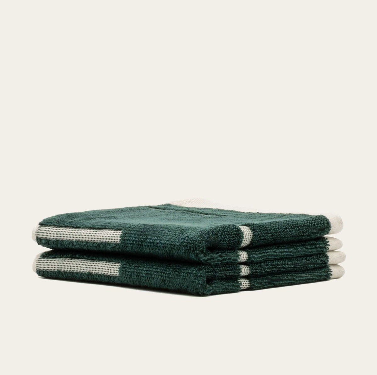 Australian cotton towel set in verdant green, folded stack with white stripe accents