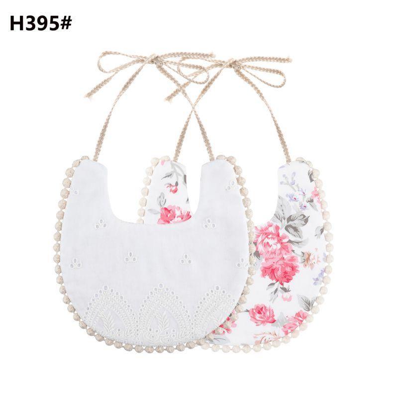 Infant double-sided bib with tassel ties, white front and pink floral reverse