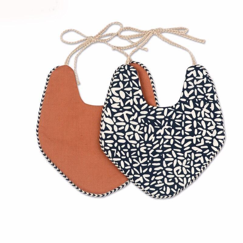Two-piece double-layer baby bib set with rust solid and navy patterned styles