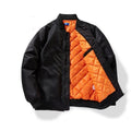 Black padded jacket with orange quilted interior and diagonal contrast panel, zip front