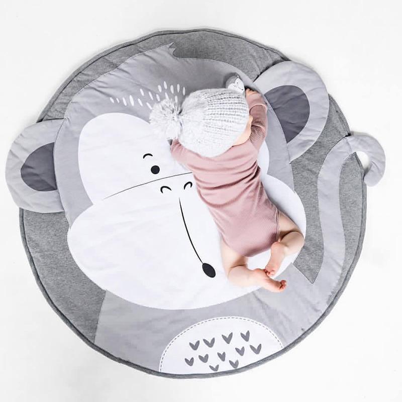 Round baby animal play mat with elephant face print, gray and white.