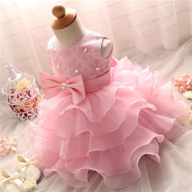 Pink lace bodice tutu dress with large satin bow and layered ruffles