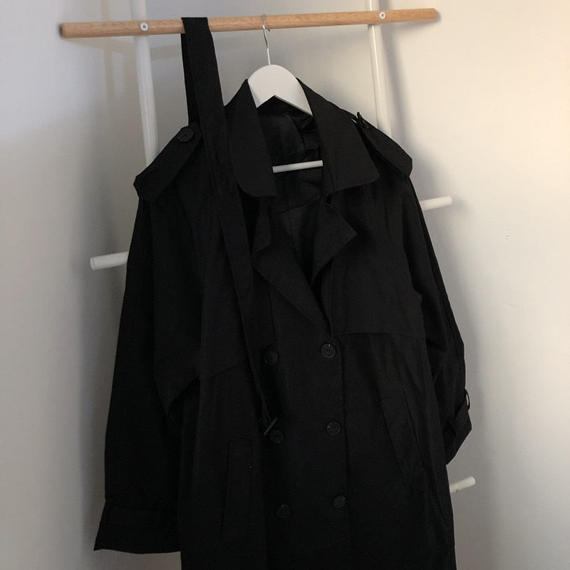Black double-breasted long overcoat close-up with button detail