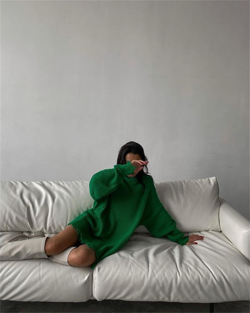 Green oversized knitted sweater dress with round neck, long sleeves, frayed hem and edges