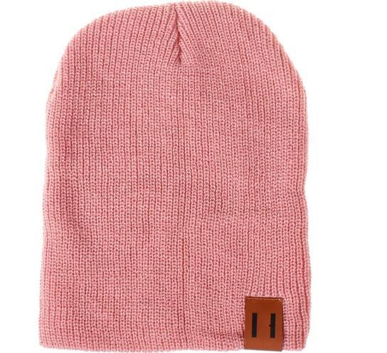 Rose pink knit beanie hat with foldover cuff and brown logo patch