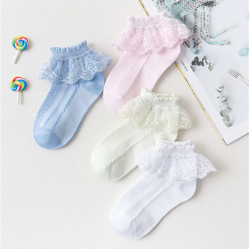 Assorted pastel lace ruffle ankle socks in light blue, pink, cream, white