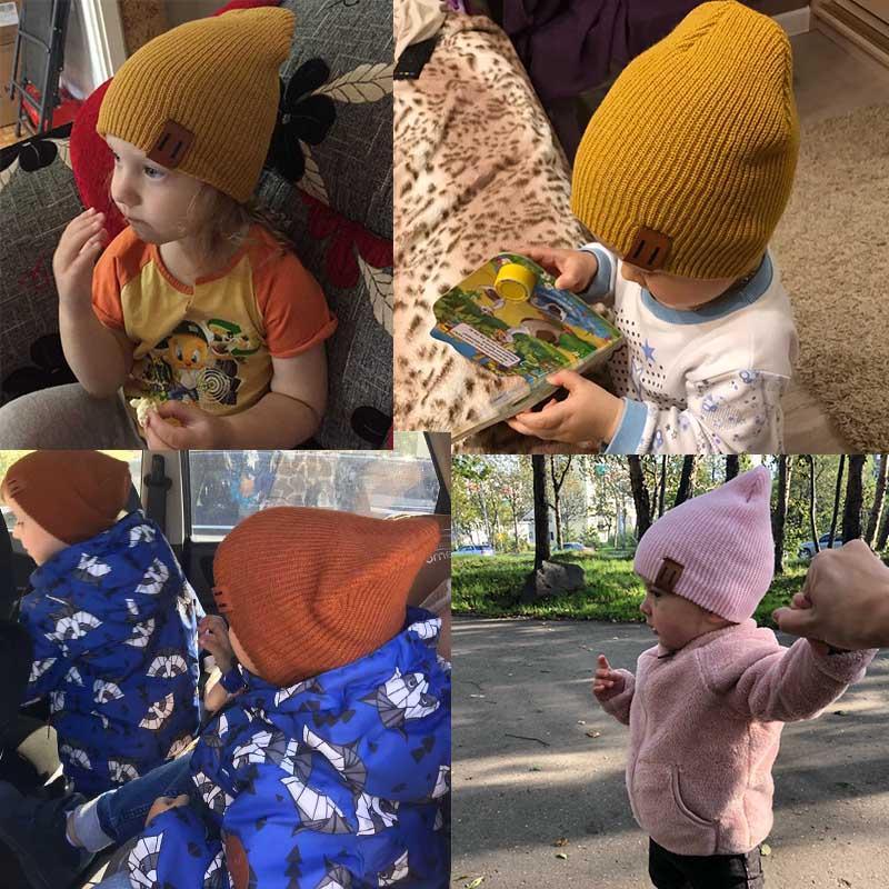 Mustard knit baby beanie and matching neck warmer worn by a child