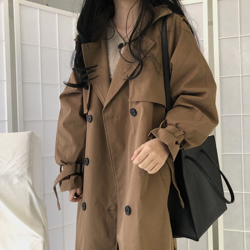 Brown double-breasted overcoat with button placket, flap pockets, and belt
