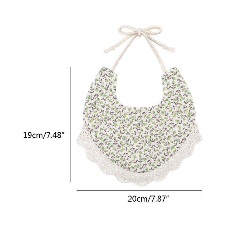 Infant bib with green floral print, scalloped lace edge, and string ties