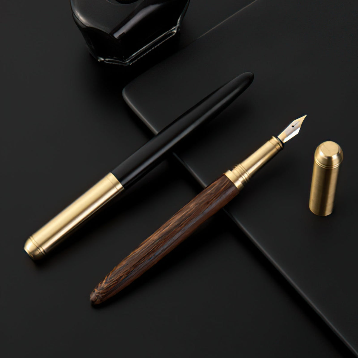 Handmade fountain pen with wood barrel, gold trim, and silver nib