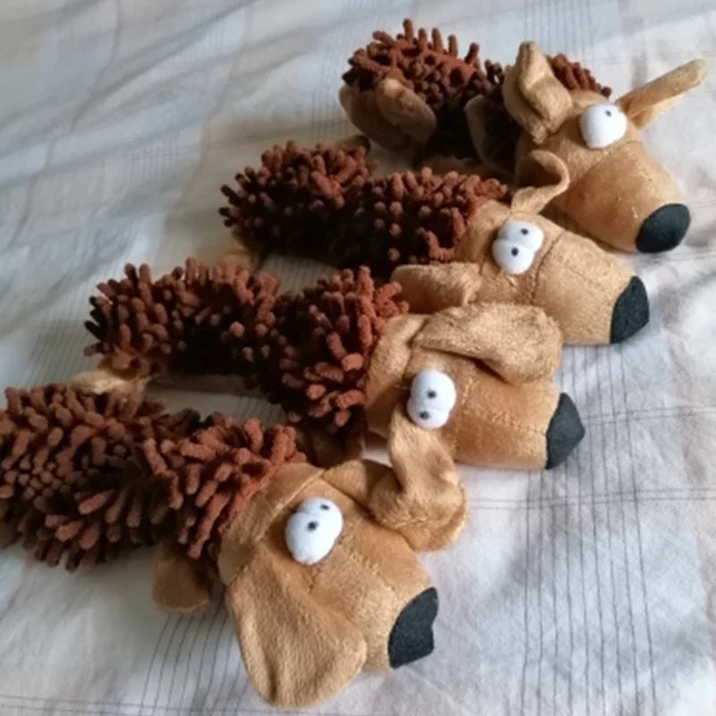 Brown plush squeaky dog chew toys with long ears and spiky backs on cloth