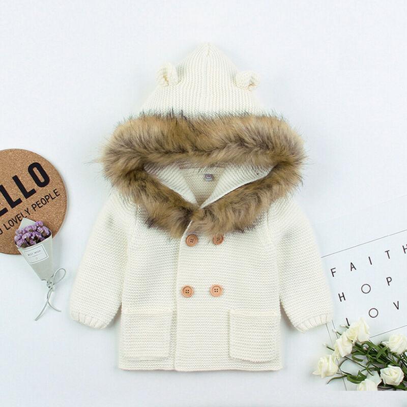 Cream newborn knit hooded coat with faux fur collar and button front