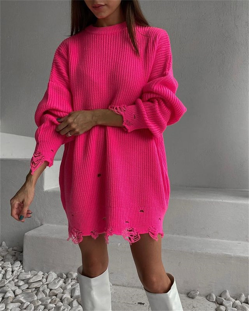 Pink knitted sweater dress with round neck and long sleeves; loose fit, frayed hem details
