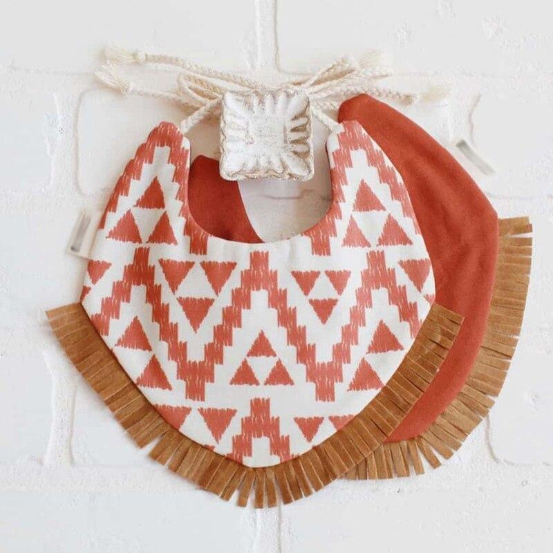Infant bandana bib set with orange zigzag print and brown fringe edges