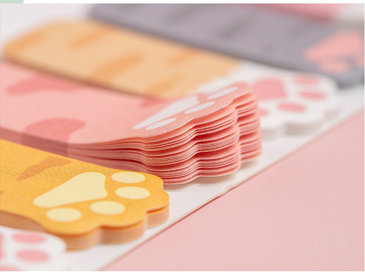 Stack of cat paw sticky note tabs in pastel colors, ready to peel and use