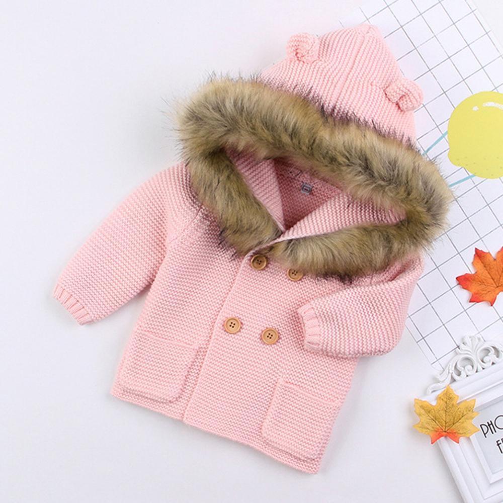 Newborn knitted hooded jacket, light pink with tan faux-fur hood trim and brown buttons
