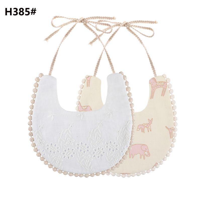 Infant double-sided bib with tassel ties, white embroidered front and beige elephant reverse
