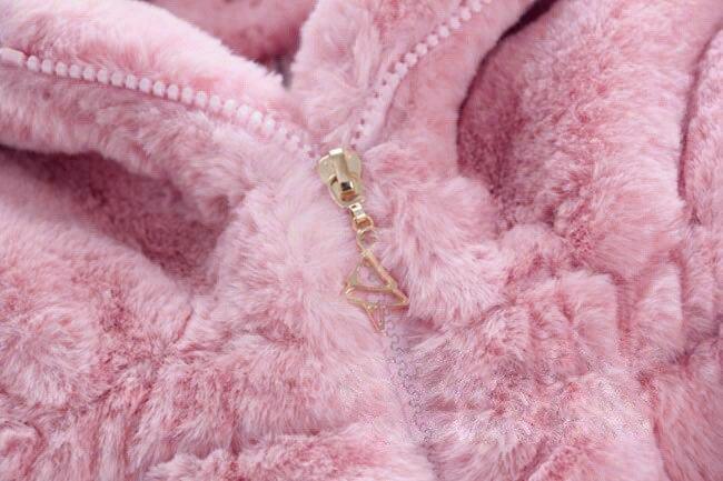 Pink plush jacket close-up, gold-tone zipper on soft fuzzy sherpa