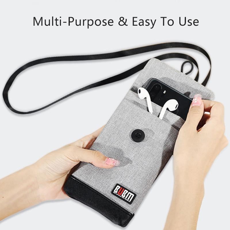 Grey waterproof phone wallet bag with flap closure, snap button, and detachable shoulder strap