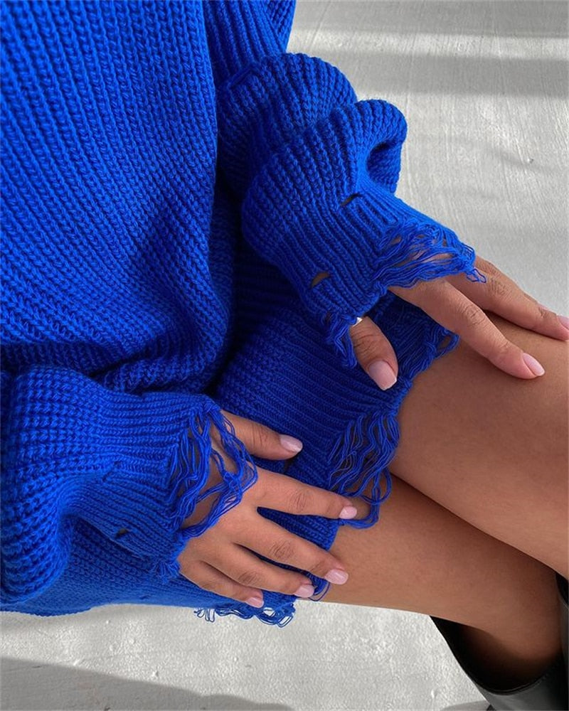 Blue knitted sweater dress sleeve and hem with frayed cuffs and open-knit texture