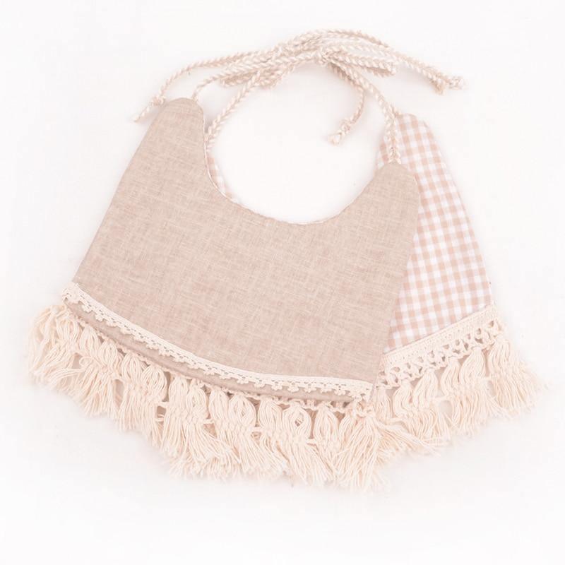 Beige solid and pink gingham double bib set with fringe trim and braided ties.