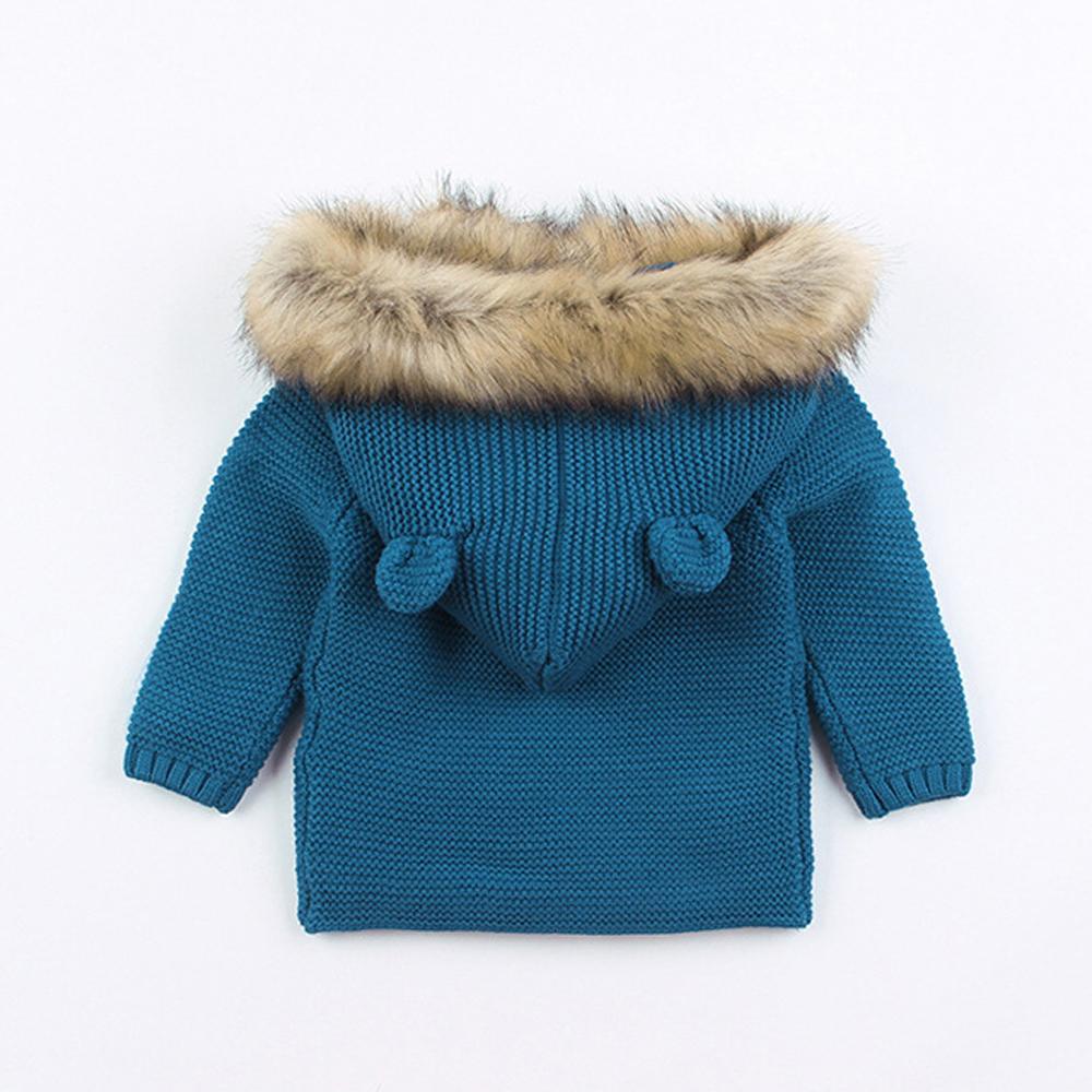 Blue knit newborn hooded coat with brown faux-fur collar and toggle-style buttons