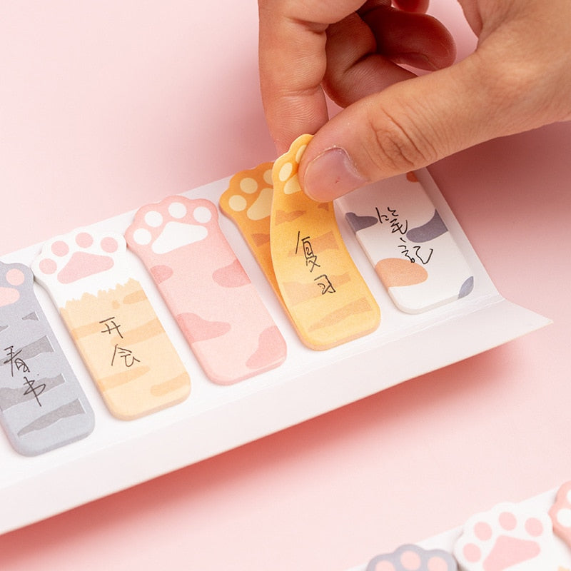 Cat paw sticky note tabs arranged in a row, with pastel colors and paw-print cutouts