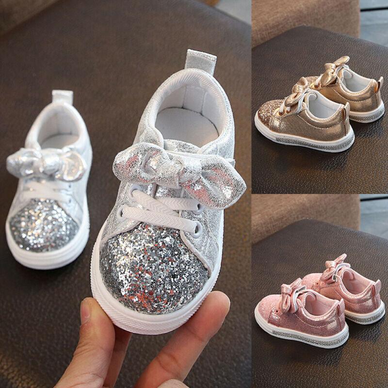 Girls silver glitter lace-up sneakers with bow detail, white rubber sole.
