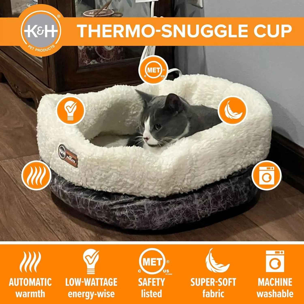 Heated cat bed with a plush white rim and gray base, shown with a cat inside