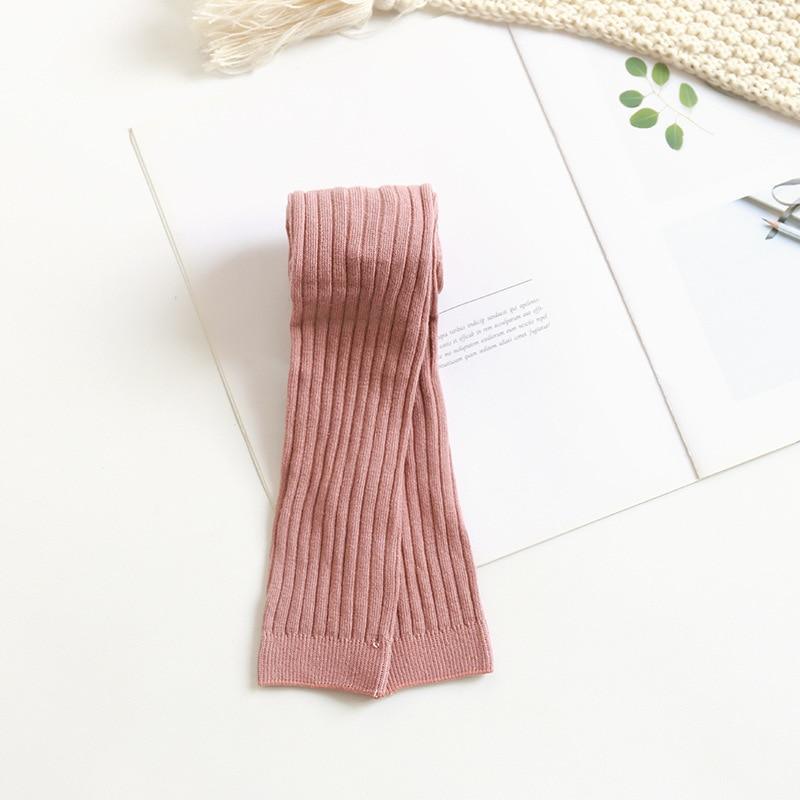 Toddler ribbed knit leggings, light pink folded on flat lay.
