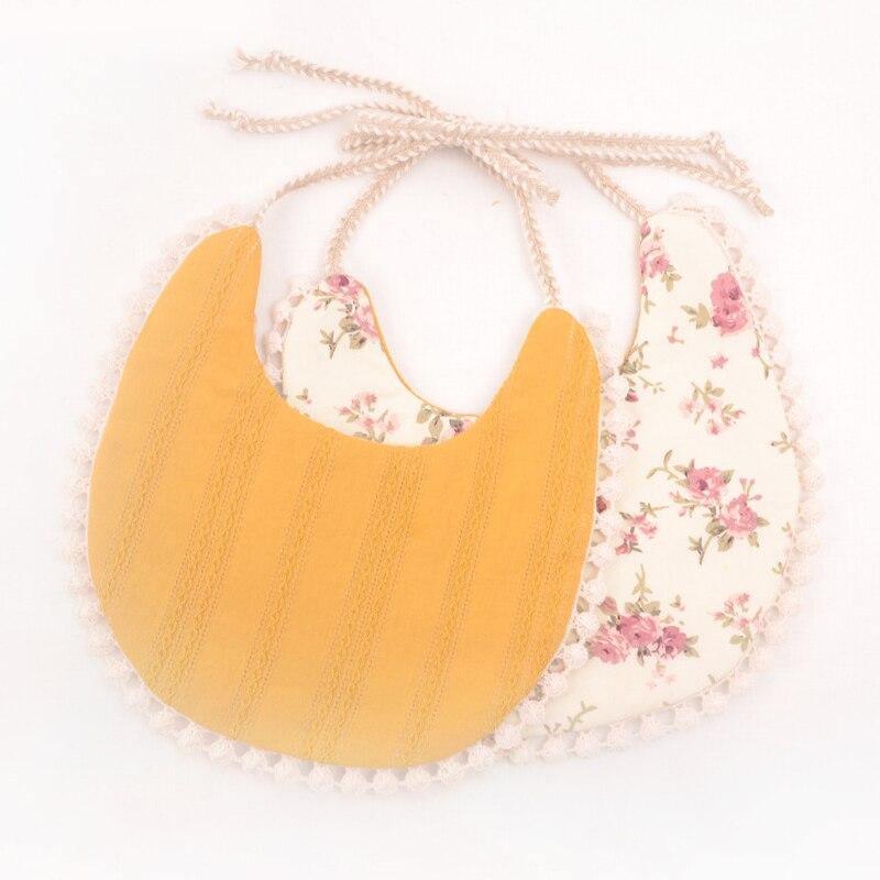 Yellow striped and floral double bib set with fringe trim and braided ties.