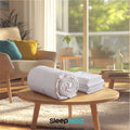White comforter set with rolled duvet and matching pillow shams
