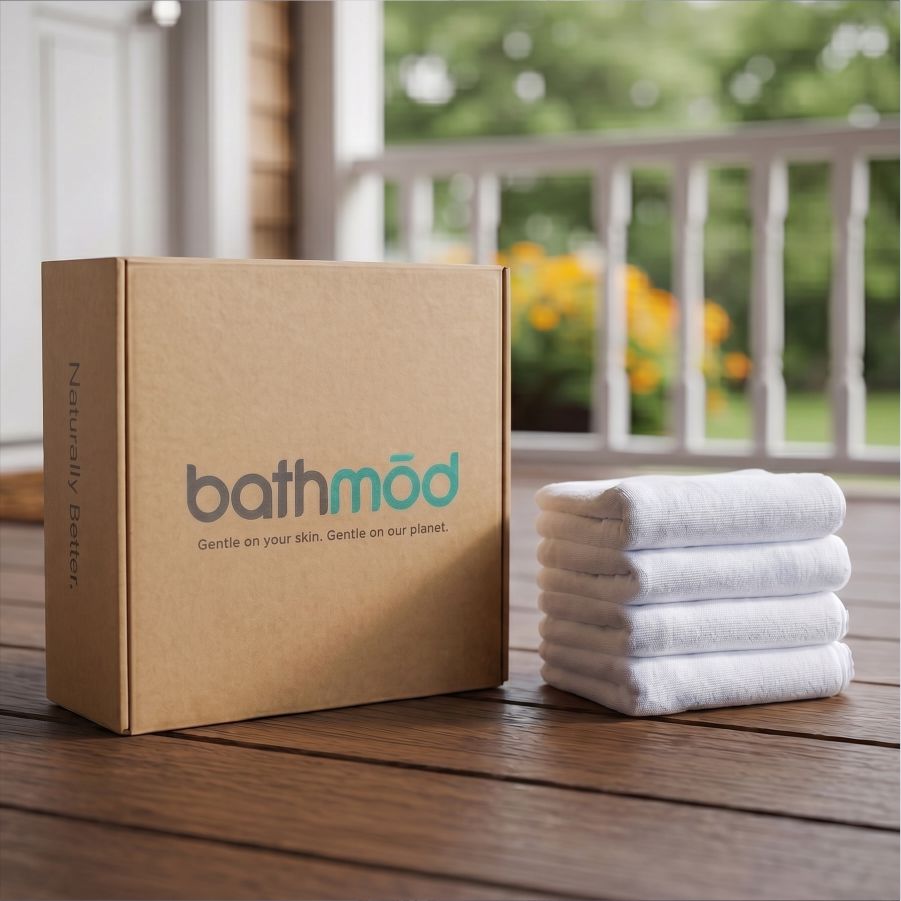 Four-pack organic bath mats, folded white mats beside a branded box