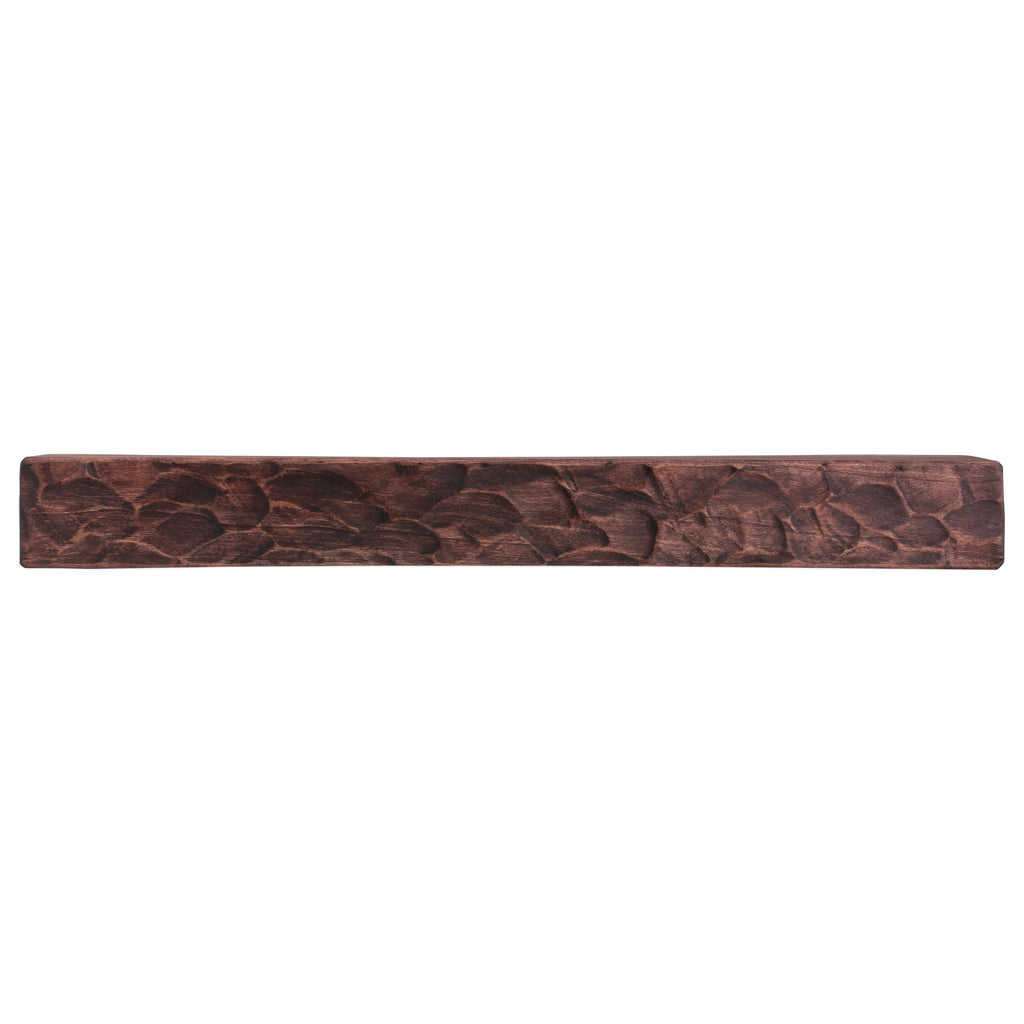 Rough-hewn wood fireplace mantel shelf, dark brown with carved grain texture