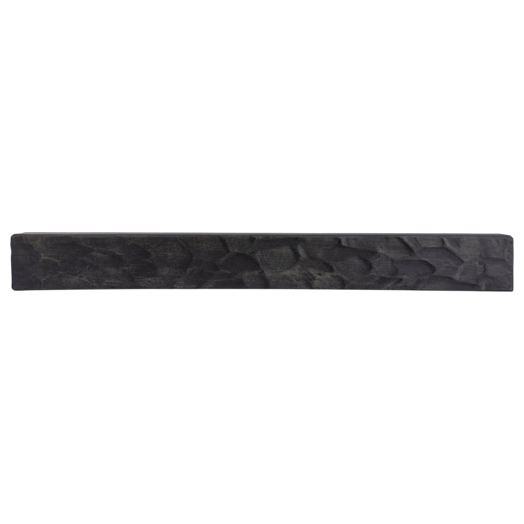 Rough-hewn wood fireplace mantel shelf in dark gray with carved stone-like texture