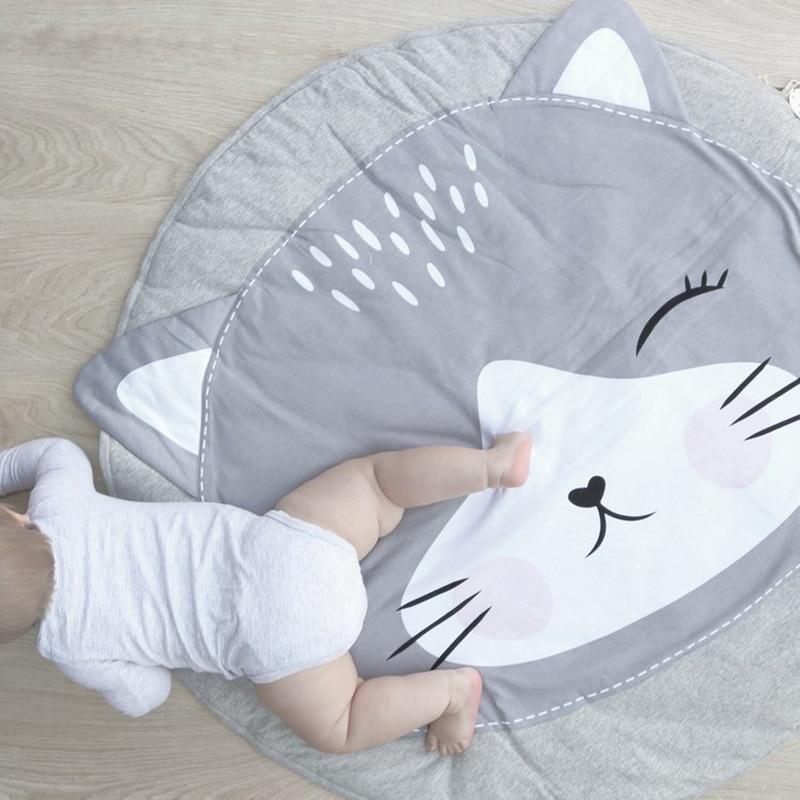 Round baby animal play mat with large white fox face, gray and white.