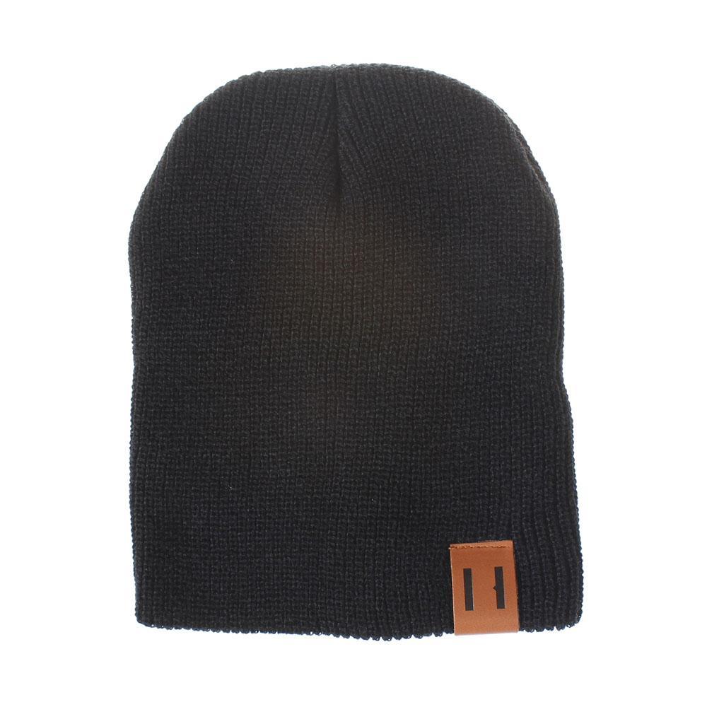 Black knit beanie hat with foldover cuff and brown logo patch